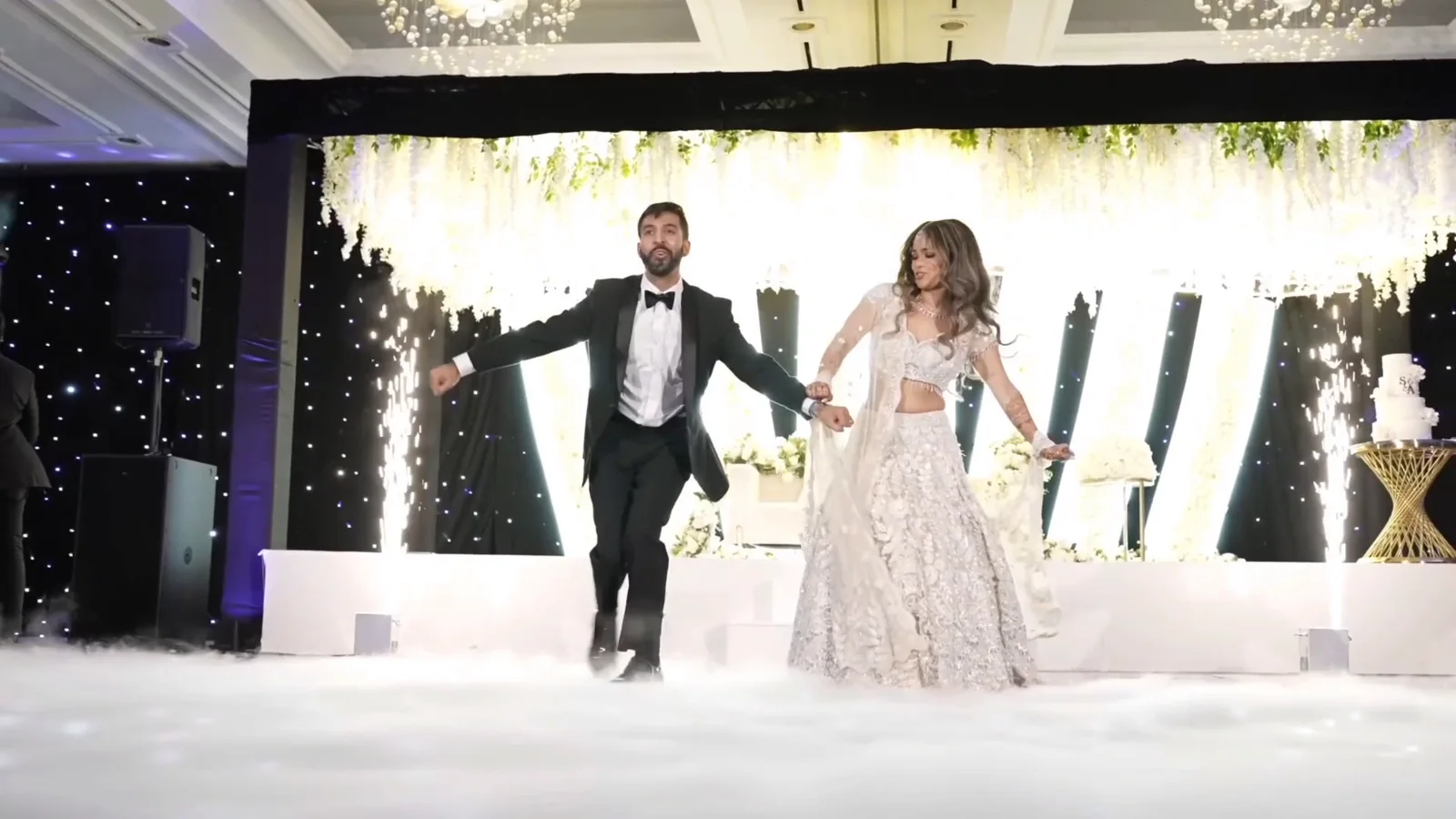 Couple dancing onstage during their Sangeet